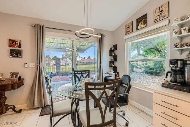 5021 Cliffrose Dr, Las Vegas, NV 89130 - dining space featuring a chandelier, light tile patterned floors, and vaulted ceiling