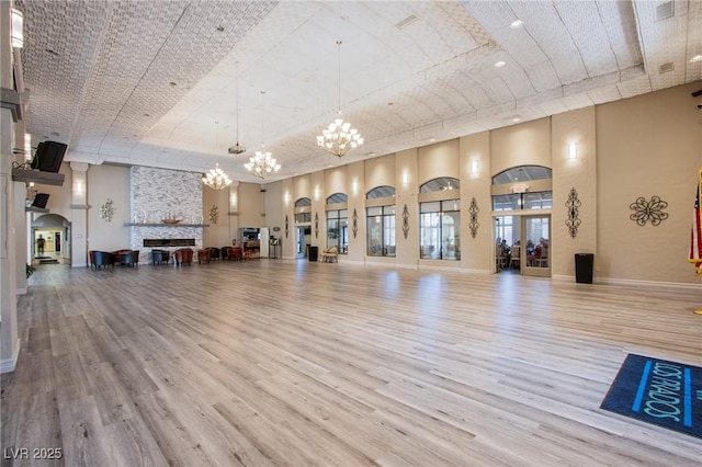 5021 Cliffrose Dr, Las Vegas, NV 89130 - workout room featuring a chandelier, wood finished floors, a high ceiling, and a tray ceiling