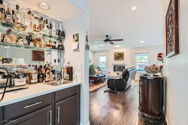 5021 Cliffrose Dr, Las Vegas, NV 89130 - indoor bar with a ceiling fan, dark wood-style floors, recessed lighting, and a glass covered fireplace