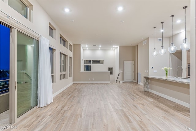 4152 Yucca Bloom St Unit 1, Las Vegas, NV 89135 - unfurnished living room featuring light wood finished floors and recessed lighting