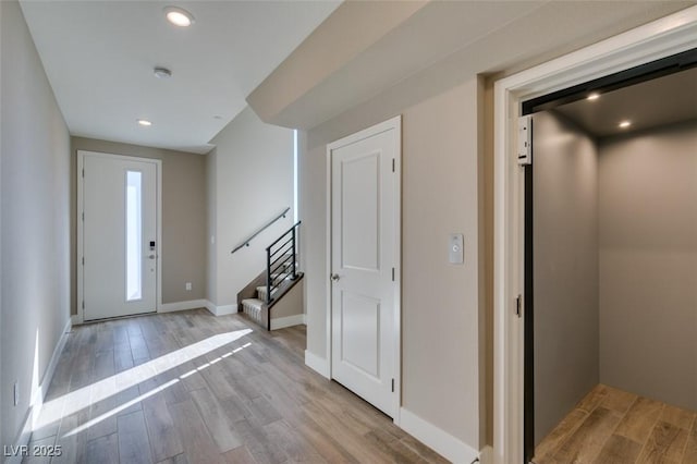 4152 Yucca Bloom St Unit 1, Las Vegas, NV 89135 - entryway with elevator, wood finished floors, stairs, and recessed lighting
