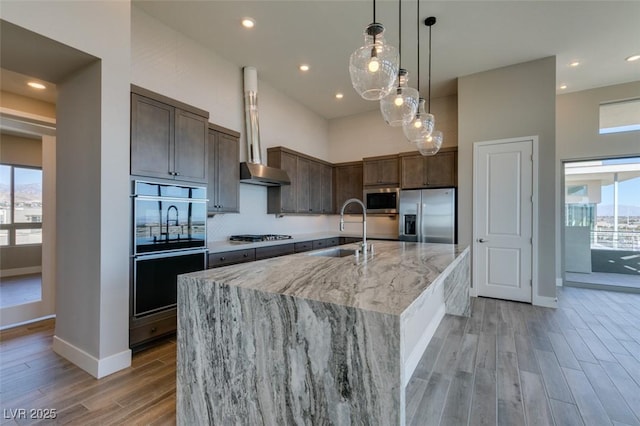 4152 Yucca Bloom St Unit 1, Las Vegas, NV 89135 - kitchen with stainless steel appliances, light wood finished floors, healthy amount of natural light, a spacious island, and recessed lighting