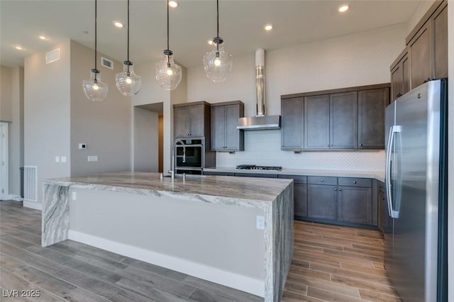 4152 Yucca Bloom St Unit 1, Las Vegas, NV 89135 - kitchen with appliances with stainless steel finishes, light wood-style floors, backsplash, light stone countertops, and recessed lighting