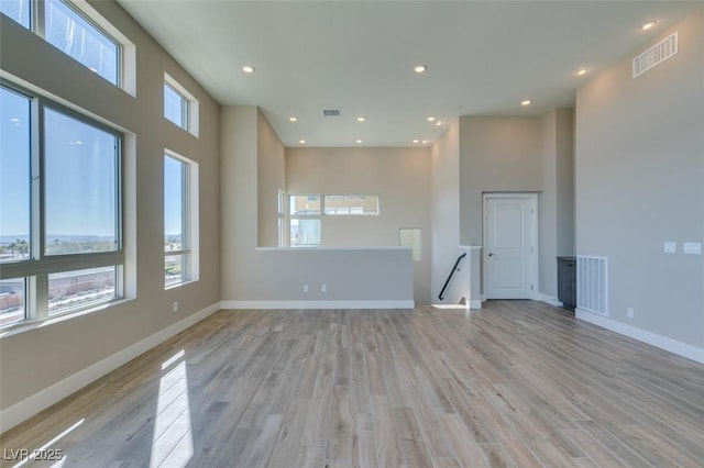 4152 Yucca Bloom St Unit 1, Las Vegas, NV 89135 - empty room with healthy amount of natural light, light wood-type flooring, recessed lighting, and a high ceiling