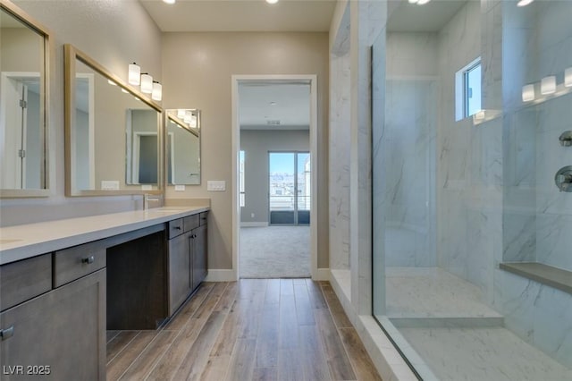 4152 Yucca Bloom St Unit 1, Las Vegas, NV 89135 - bathroom featuring double vanity, wood finished floors, a marble finish shower, and recessed lighting