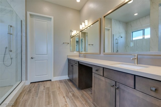 4152 Yucca Bloom St Unit 1, Las Vegas, NV 89135 - bathroom featuring a marble finish shower, double vanity, wood finish floors, and recessed lighting