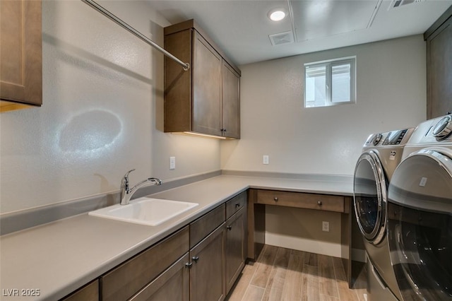4152 Yucca Bloom St Unit 1, Las Vegas, NV 89135 - laundry area with washer and dryer, cabinet space, and light wood-style floors