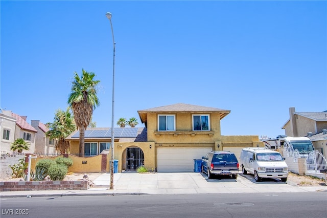 5134 Caliente St, Las Vegas, NV 89119 - traditional-style house featuring driveway, solar panels, an attached garage, and stucco siding