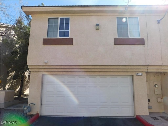 1128 Dusty Creek St, Las Vegas, NV 89128 - view of front facade with stucco siding, a garage, and asphalt driveway
