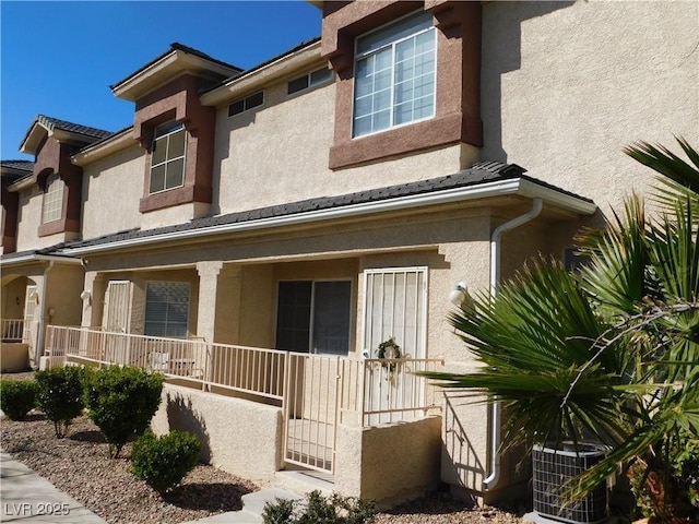 1128 Dusty Creek St, Las Vegas, NV 89128 - view of side of property with stucco siding and covered porch