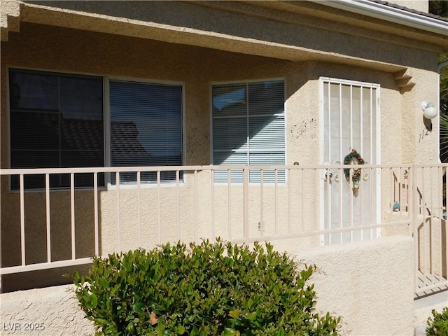 1128 Dusty Creek St, Las Vegas, NV 89128 - view of side of home with stucco siding and a balcony