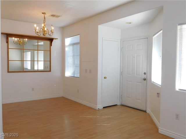 1128 Dusty Creek St, Las Vegas, NV 89128 - foyer entrance featuring a chandelier and light wood-style flooring