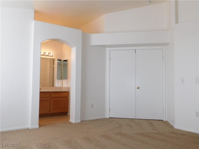 1128 Dusty Creek St, Las Vegas, NV 89128 - unfurnished bedroom featuring arched walkways, light colored carpet, a closet, and ensuite bathroom