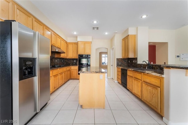 8901 Goldstone Ave, Las Vegas, NV 89143 - kitchen with black appliances, under cabinet range hood, a center island, arched walkways, and dark stone countertops