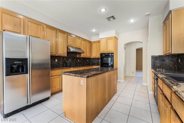 8901 Goldstone Ave, Las Vegas, NV 89143 - kitchen featuring stainless steel fridge, black oven, under cabinet range hood, arched walkways, and light tile patterned flooring