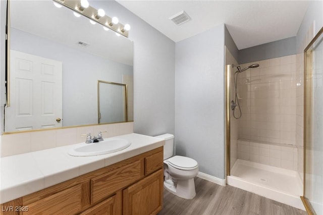 8901 Goldstone Ave, Las Vegas, NV 89143 - bathroom featuring vanity, wood finished floors, and a tile shower