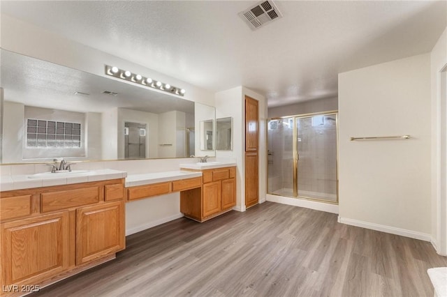 8901 Goldstone Ave, Las Vegas, NV 89143 - full bathroom featuring wood finished floors, double vanity, and a stall shower