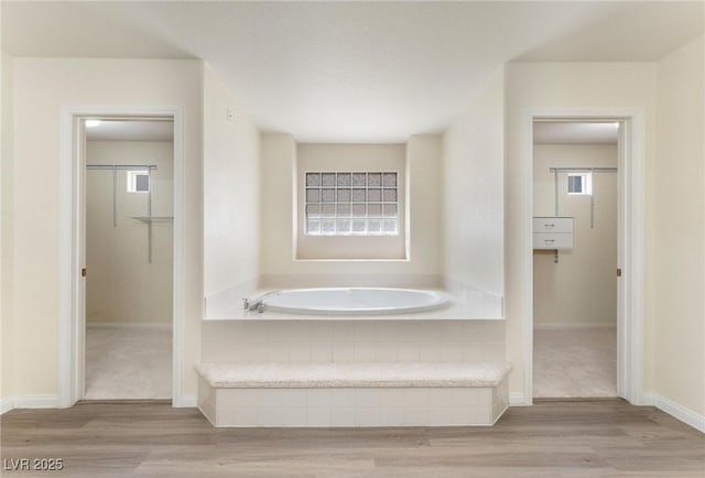 8901 Goldstone Ave, Las Vegas, NV 89143 - bathroom with a bath, wood finished floors, and a walk in closet