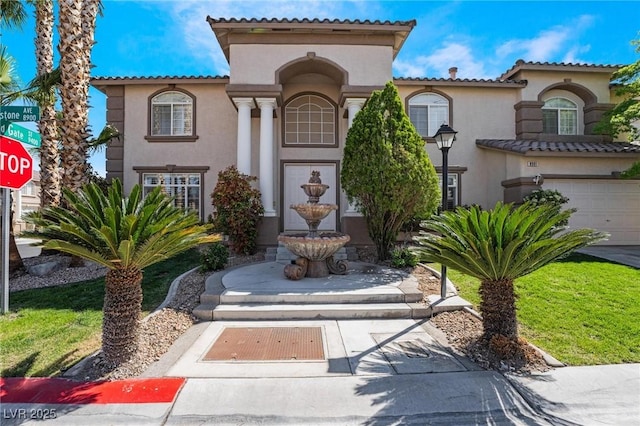 8901 Goldstone Ave, Las Vegas, NV 89143 - mediterranean / spanish-style house with stucco siding, a tiled roof, and a garage