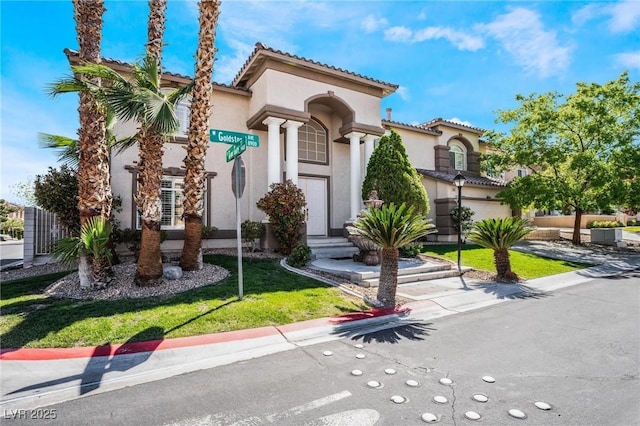 8901 Goldstone Ave, Las Vegas, NV 89143 - mediterranean / spanish home with stucco siding, a front lawn, and a tile roof