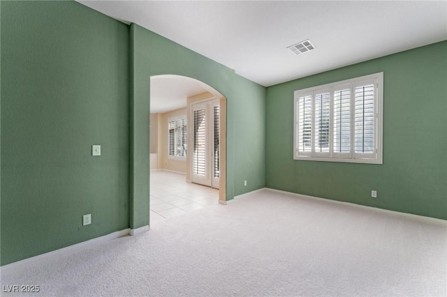 8901 Goldstone Ave, Las Vegas, NV 89143 - carpeted empty room with arched walkways and tile patterned flooring