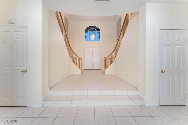8901 Goldstone Ave, Las Vegas, NV 89143 - entryway featuring stairway, light tile patterned floors, and a high ceiling