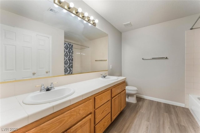8901 Goldstone Ave, Las Vegas, NV 89143 - full bath with double vanity, wood finished floors, and shower / bath combo