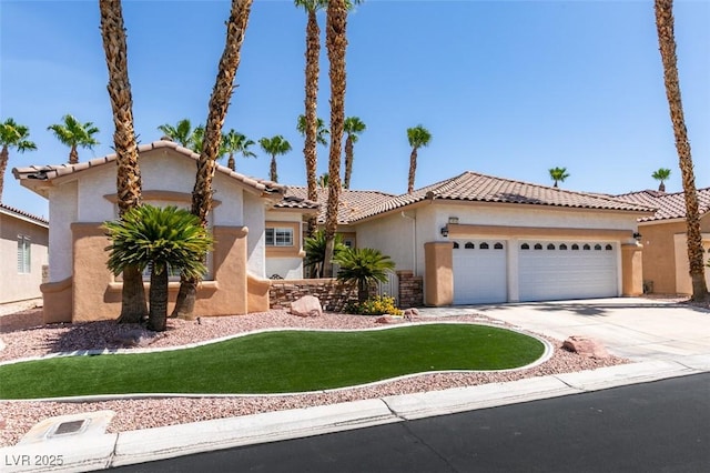 1414 Doggett Ave, Las Vegas, NV 89123 - mediterranean / spanish house featuring stucco siding, an attached garage, a tiled roof, a front lawn, and driveway