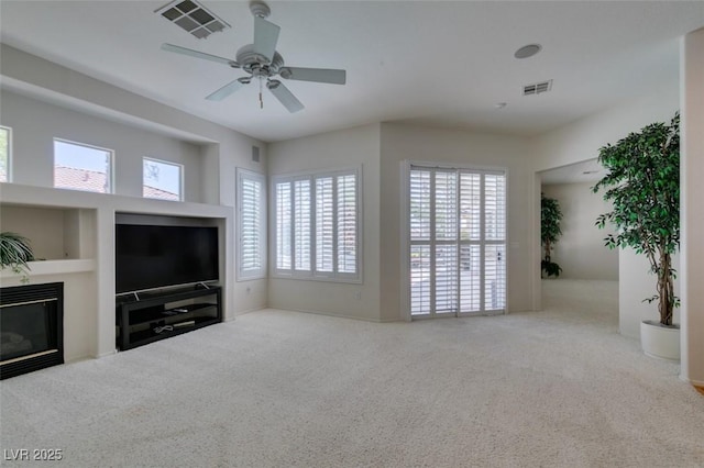 1414 Doggett Ave, Las Vegas, NV 89123 - unfurnished living room with carpet floors, plenty of natural light, and a glass covered fireplace