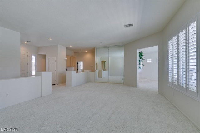1414 Doggett Ave, Las Vegas, NV 89123 - unfurnished living room featuring plenty of natural light, recessed lighting, and light colored carpet