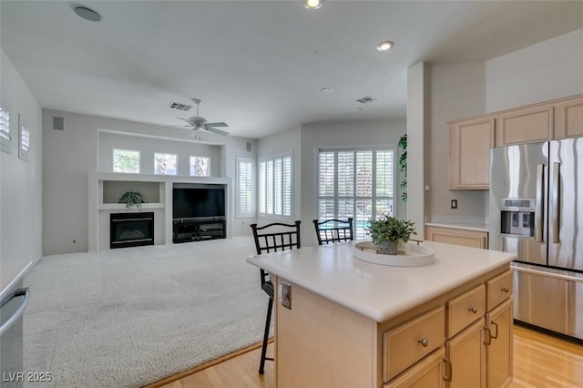 1414 Doggett Ave, Las Vegas, NV 89123 - kitchen with stainless steel fridge, light brown cabinetry, a ceiling fan, light countertops, and recessed lighting