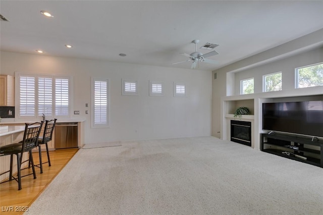 1414 Doggett Ave, Las Vegas, NV 89123 - living area featuring recessed lighting, ceiling fan, a glass covered fireplace, and light carpet
