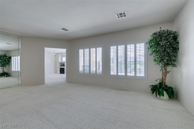 1414 Doggett Ave, Las Vegas, NV 89123 - carpeted spare room with a ceiling fan and a fireplace