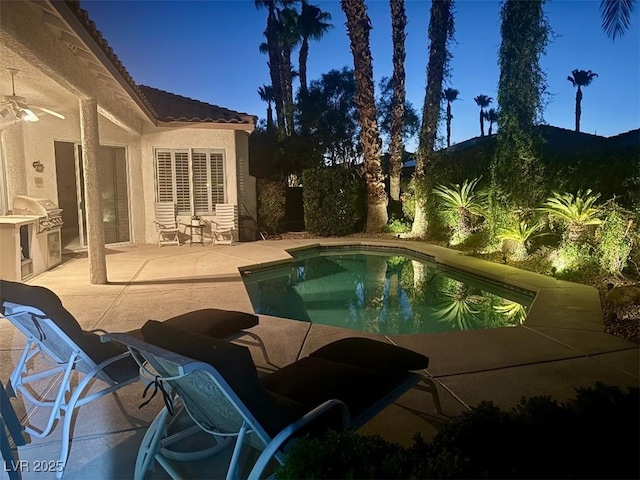 1414 Doggett Ave, Las Vegas, NV 89123 - pool at twilight featuring exterior kitchen, an outdoor pool, and a patio