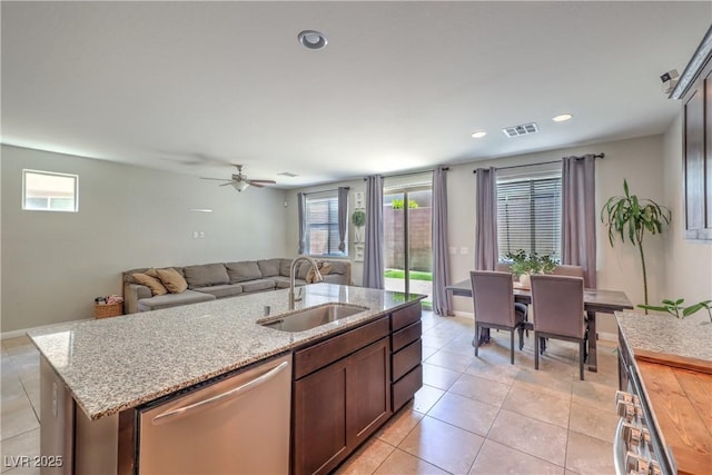 9237 S Chieftain St, Las Vegas, NV 89178 - kitchen with dishwasher, light tile patterned floors, a kitchen island with sink, light stone countertops, and recessed lighting