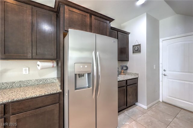 9237 S Chieftain St, Las Vegas, NV 89178 - kitchen featuring fridge with ice dispenser, dark brown cabinets, light tile patterned flooring, light stone counters, and lofted ceiling