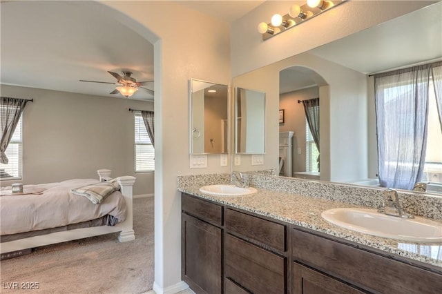 9237 S Chieftain St, Las Vegas, NV 89178 - bathroom featuring double vanity, healthy amount of natural light, a ceiling fan, and ensuite bath