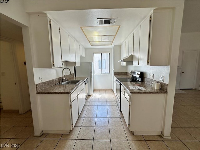 4320 Gannet Cir Unit 116, Las Vegas, NV 89103 - kitchen featuring appliances with stainless steel finishes, dark countertops, under cabinet range hood, and light tile patterned flooring