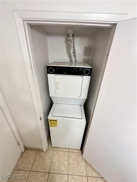 4320 Gannet Cir Unit 116, Las Vegas, NV 89103 - laundry room with stacked washing machine and dryer and light tile patterned flooring