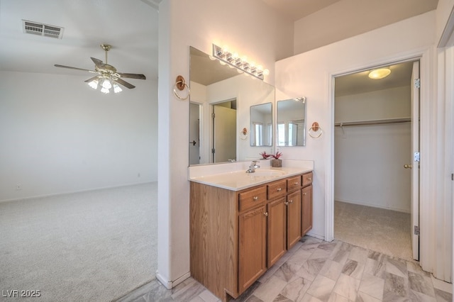 5209 Mantua Ct, Las Vegas, NV 89130 - bathroom with vanity, a ceiling fan, and a spacious closet