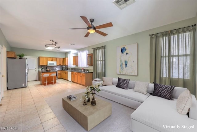 5209 Mantua Ct, Las Vegas, NV 89130 - living area with a ceiling fan and light tile patterned flooring