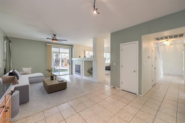 5209 Mantua Ct, Las Vegas, NV 89130 - living room featuring light tile patterned floors, a fireplace, and ceiling fan