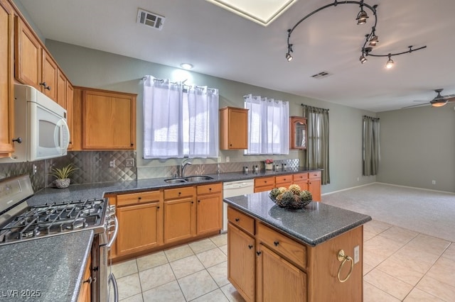 5209 Mantua Ct, Las Vegas, NV 89130 - kitchen with white appliances, light tile patterned floors, open floor plan, and a center island