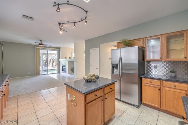 5209 Mantua Ct, Las Vegas, NV 89130 - kitchen featuring stainless steel fridge, light carpet, a center island, a ceiling fan, and tasteful backsplash