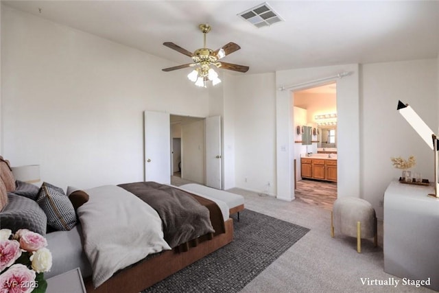 5209 Mantua Ct, Las Vegas, NV 89130 - bedroom featuring light colored carpet, connected bathroom, and ceiling fan