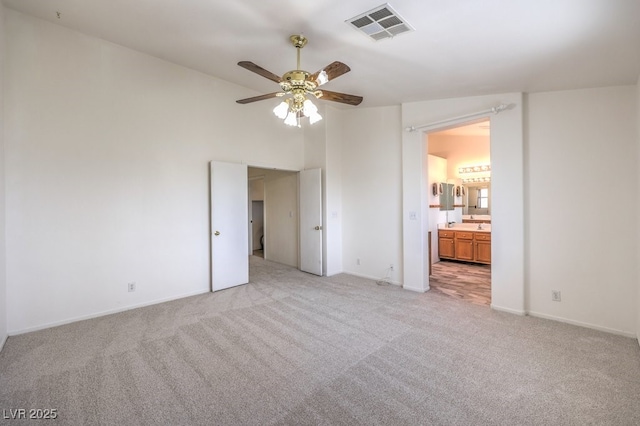 5209 Mantua Ct, Las Vegas, NV 89130 - unfurnished bedroom featuring light carpet, ensuite bath, and ceiling fan