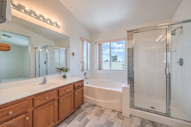 5209 Mantua Ct, Las Vegas, NV 89130 - bathroom with lofted ceiling, vanity, a stall shower, and a garden tub