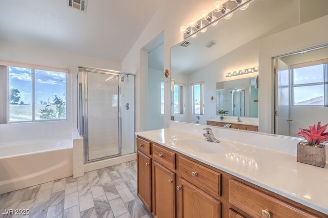 5209 Mantua Ct, Las Vegas, NV 89130 - full bathroom with vaulted ceiling, a shower stall, a garden tub, vanity, and marble finish floors