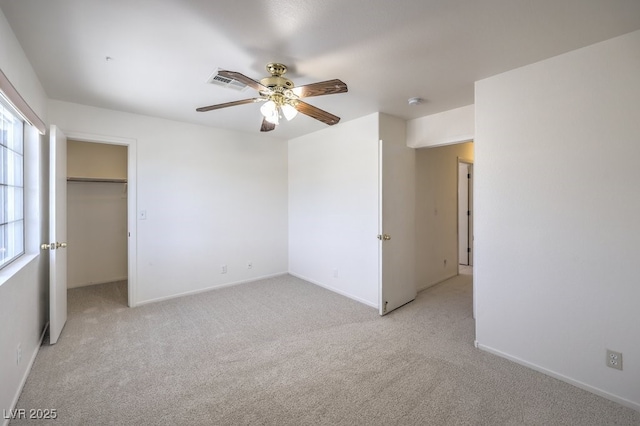 5209 Mantua Ct, Las Vegas, NV 89130 - unfurnished bedroom featuring light colored carpet, a ceiling fan, and a walk in closet