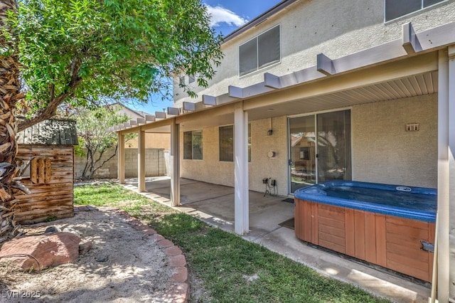 5209 Mantua Ct, Las Vegas, NV 89130 - rear view of property featuring a hot tub, stucco siding, and a patio